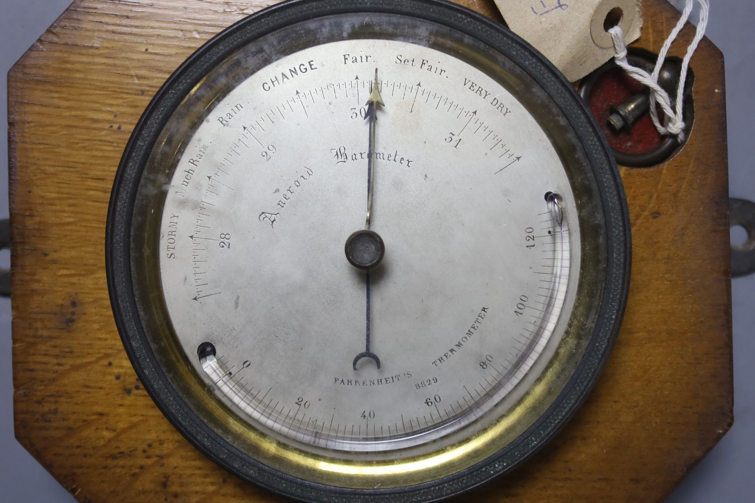 An Edwardian oak cased travelling aneroid barometer, height 19cm